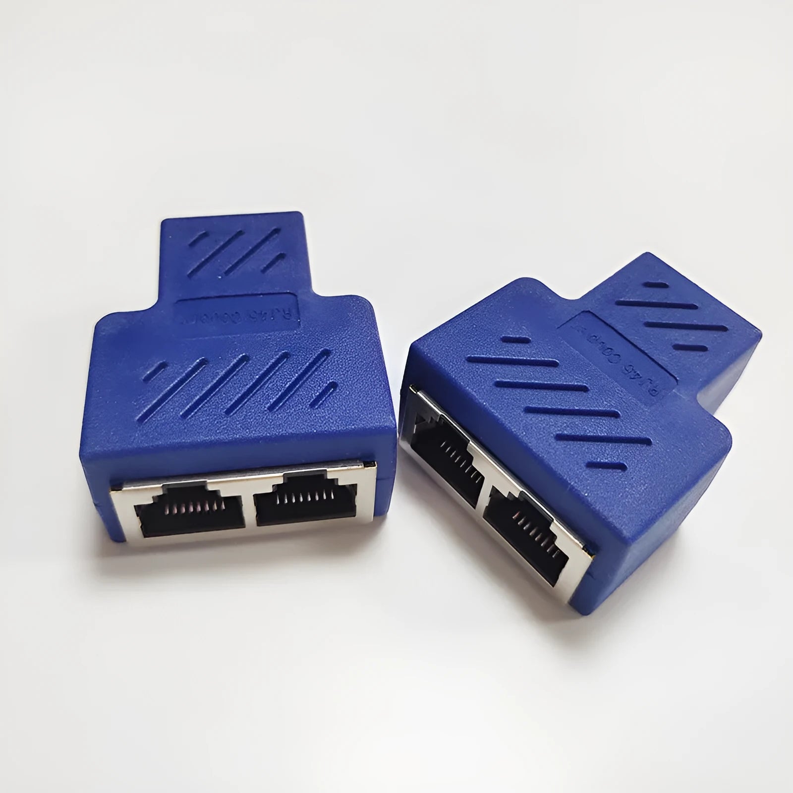 White RJ45 network cable splitter showing one male plug and two female Ethernet ports.