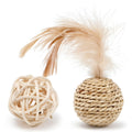 Two cat toys: a faux feather bell ball and a hollow rattan ball on a plain background.
