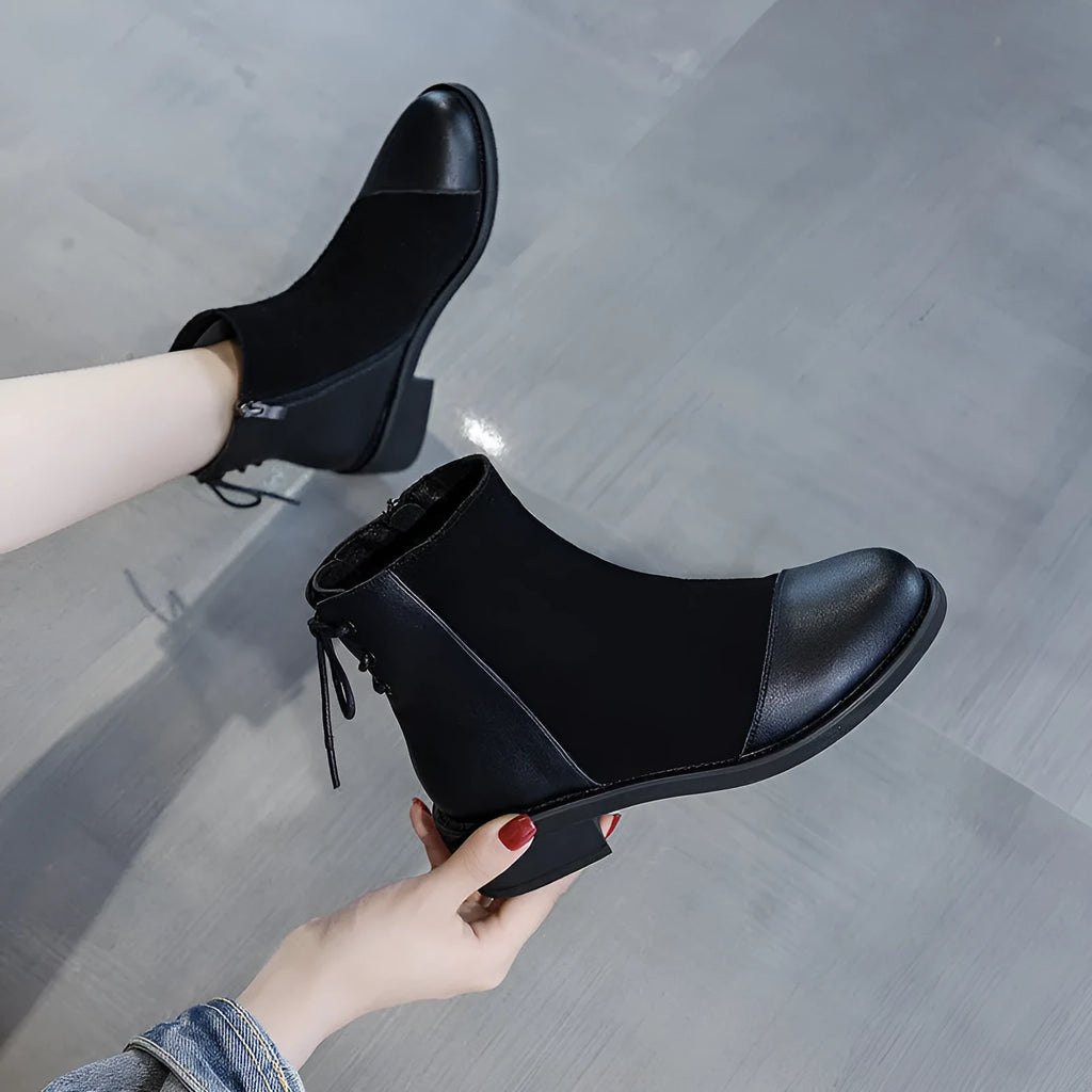 Black women's Martin boots with side zip, round toe, and knee-length shaft