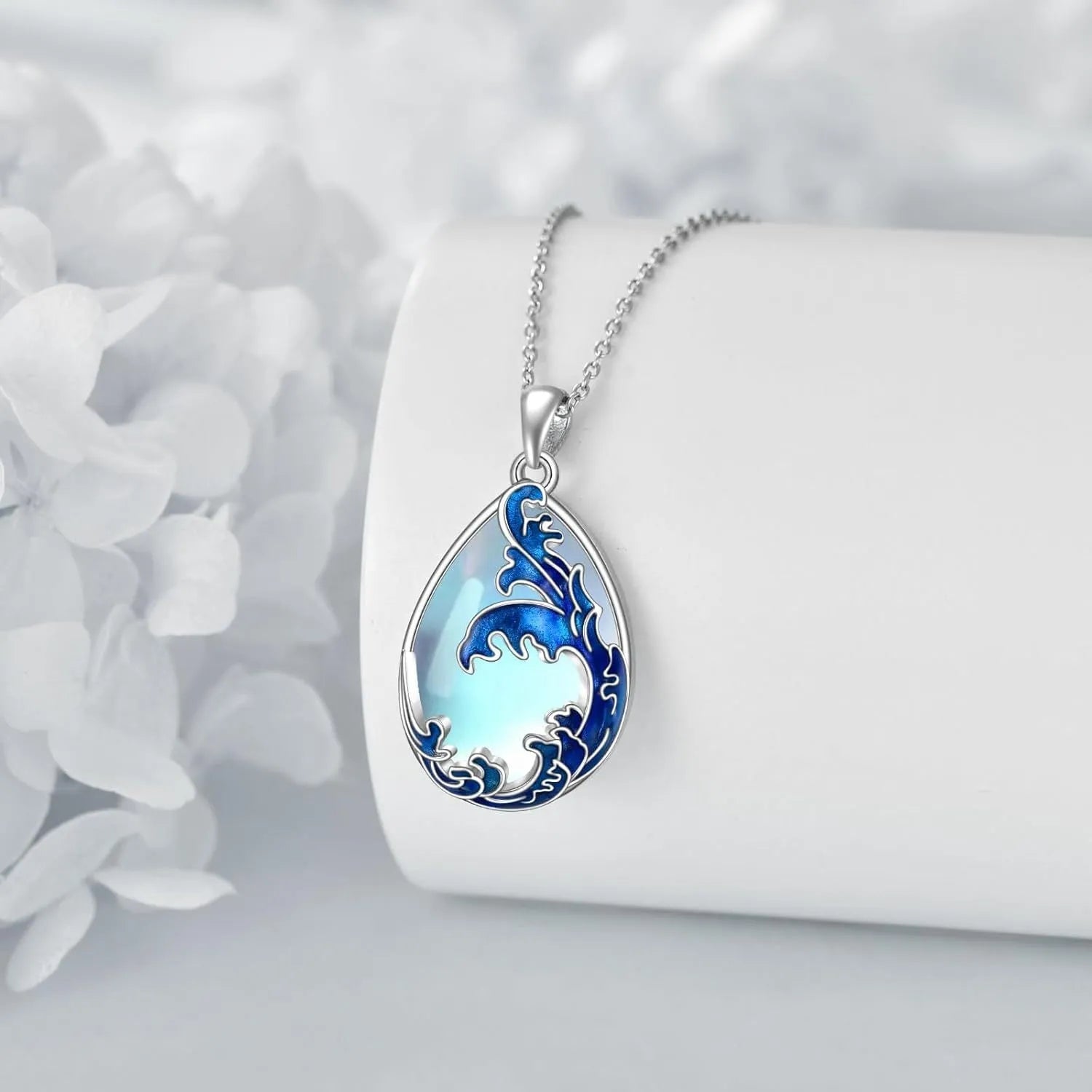 Blue heart pendant necklace on silver-tone chain with moonstone blue finish
