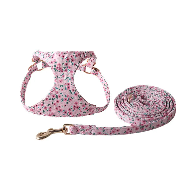 Cloth dog harness and leash set shown in various colours including a floral print, for small dogs.