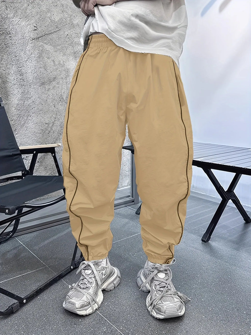 Man wearing blue cropped bamboo fibre sports trousers with a loose, elasticated fit.