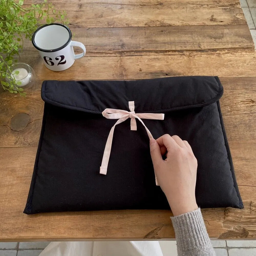 Black and white striped quilted laptop bag with ballet-style bow for women