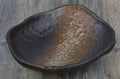 Irregular shaped Japanese coarse pottery bowl with floral decoration measuring 24cm length