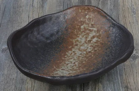 Irregular shaped Japanese coarse pottery bowl with floral decoration measuring 24cm length
