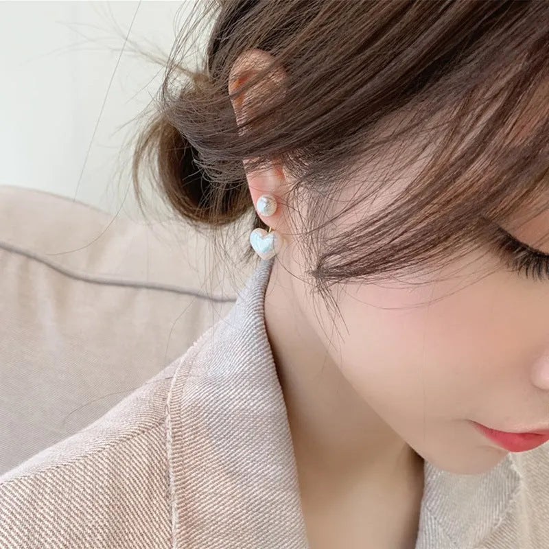 Korean style heart-shaped alloy stud earrings for women with artificial gem inlay on a white background.