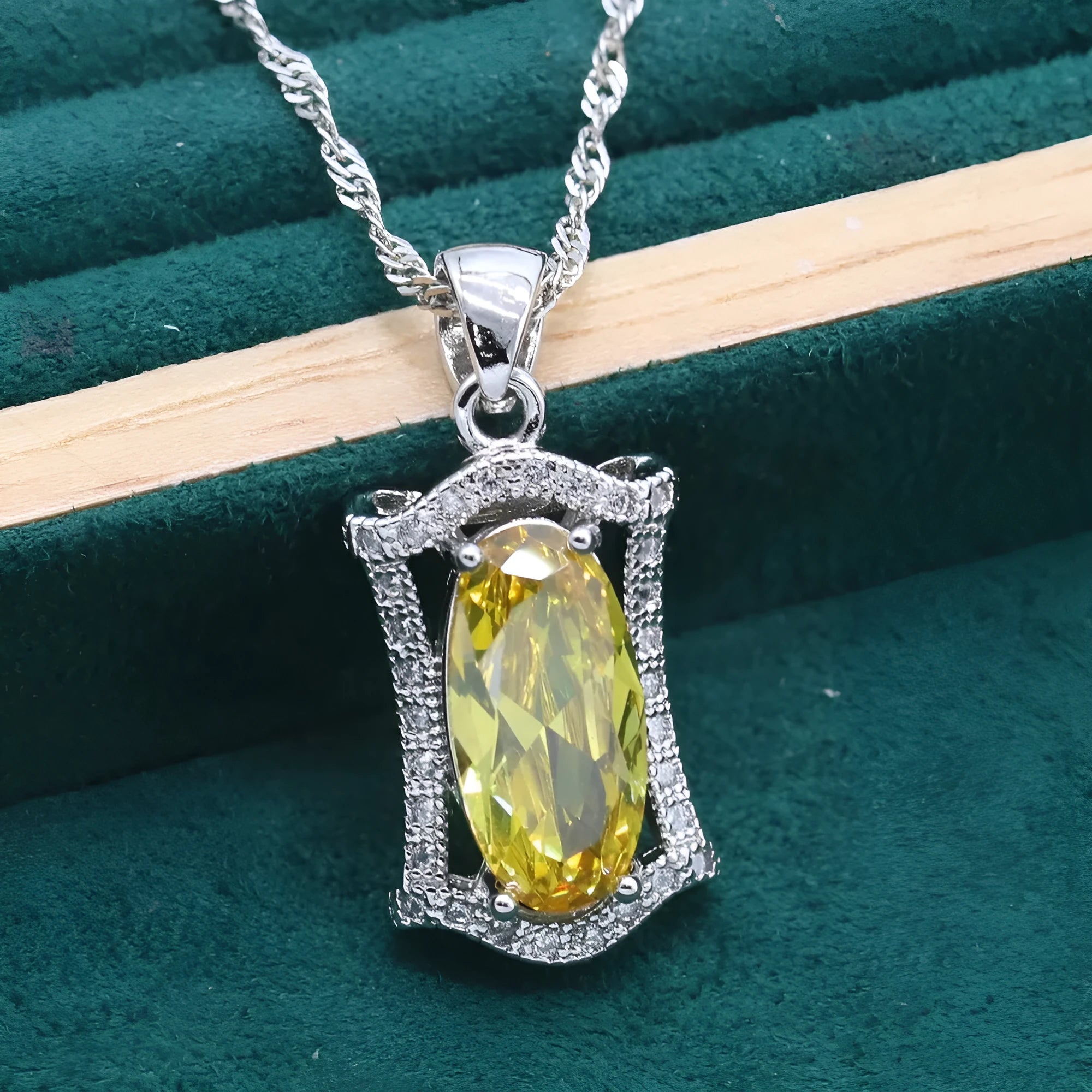 Yellow and olive alloy zircon jewellery set for women showing necklace, earrings, ring, and bracelet on display.