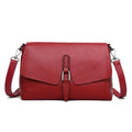 Women's soft cowhide shoulder bag in Wine Red with three main pockets and adjustable strap on white background
