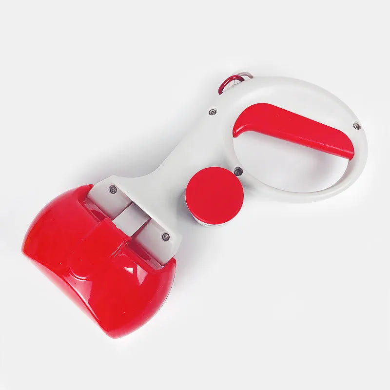 Black pet pooper scooper with built-in trash bag holder and carrying hook on a gravel path.
