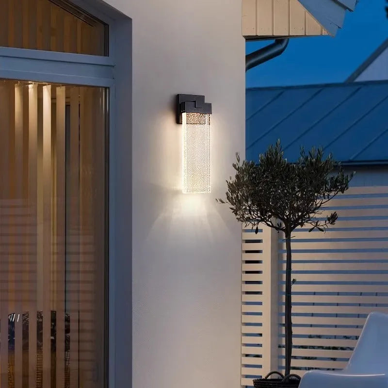 Black outdoor LED wall lamp in stainless steel with warm light for courtyards and corridors