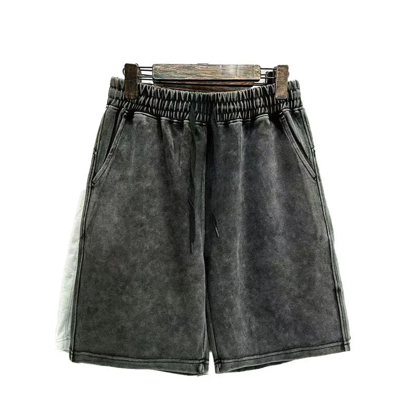 Men's charcoal black cotton shorts with a distressed style and loose straight-leg fit