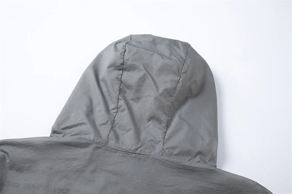 Men's nylon sun protection jacket with letters print in gray, shown on a model