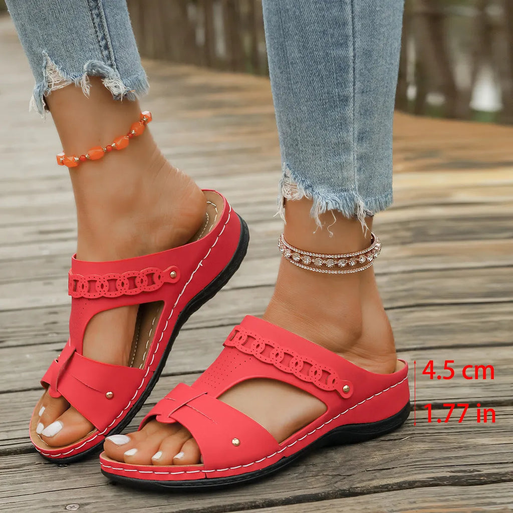 Blue roman style slippers with fish mouth toe and slope heel on a rubber sole.