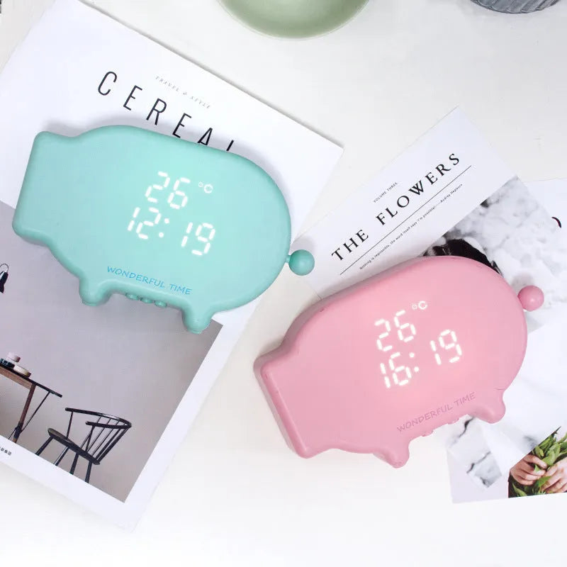 Blue and pink multifunctional LED digital alarm clock displaying time and temperature, with USB charging cable