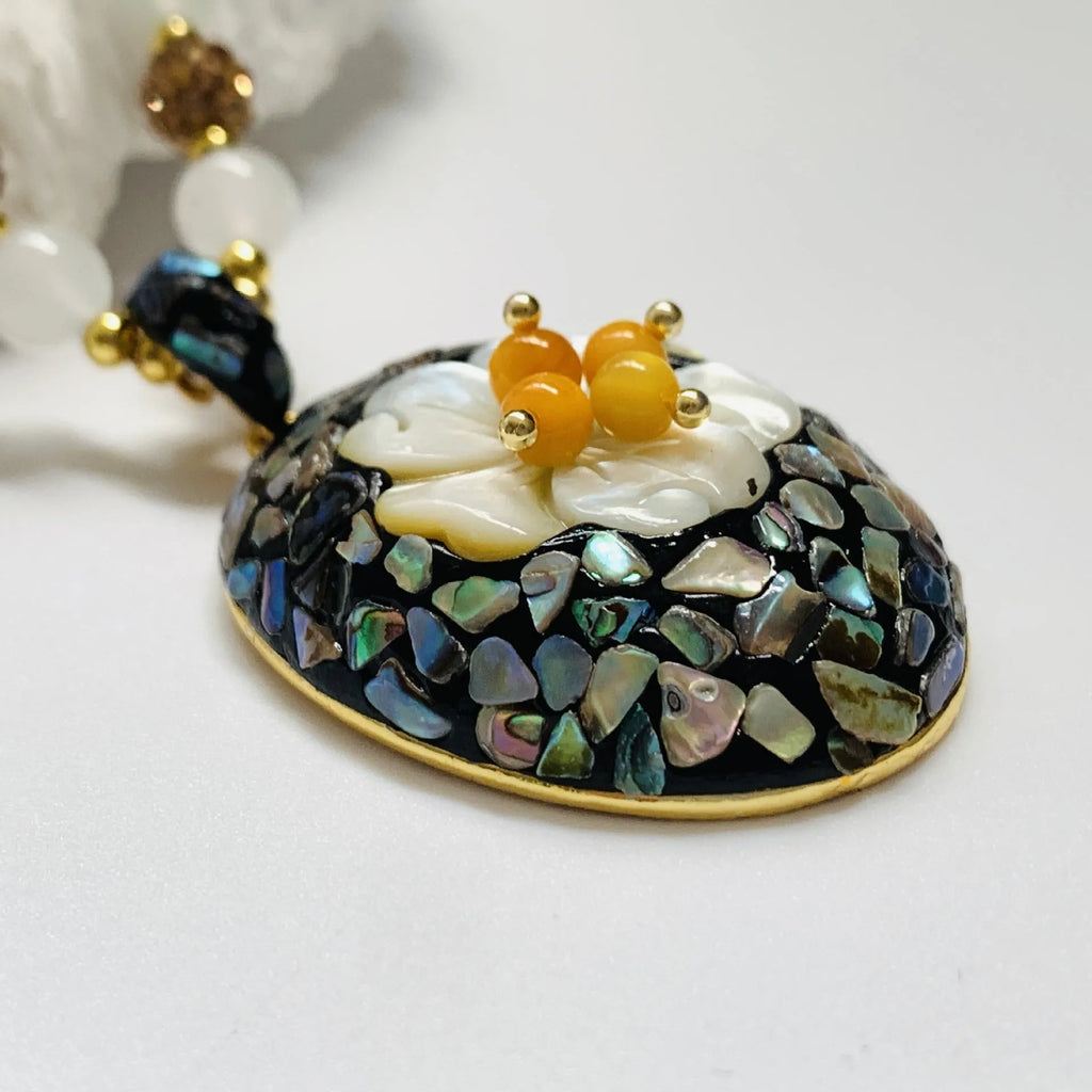 Original design mother-of-pearl shell necklace with rhinestone accents and twist chain
