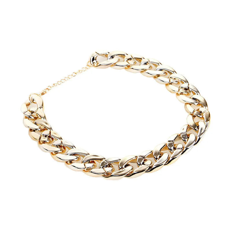 Gold chain dog collar necklace with a geometric buckle on a small dog