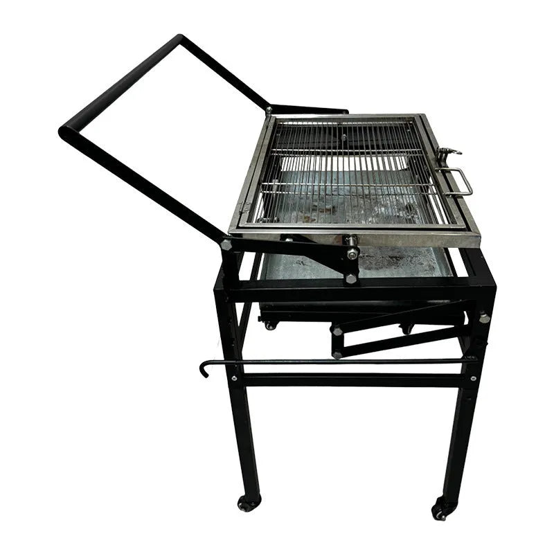 Large foldable Flip BBQ charcoal grill with detachable legs set up in a garden.