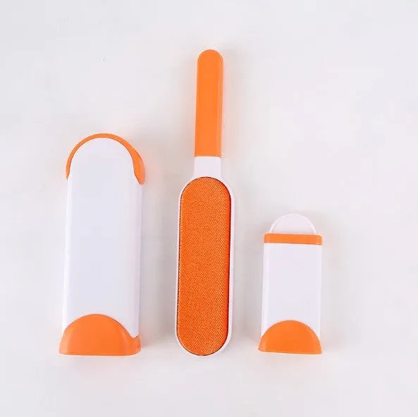 Blue reusable pet hair removal comb with double-sided brush next to its self-cleaning base.