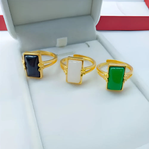 Adjustable gold-plated brass ring with a black gemstone inlay on a model's hand.