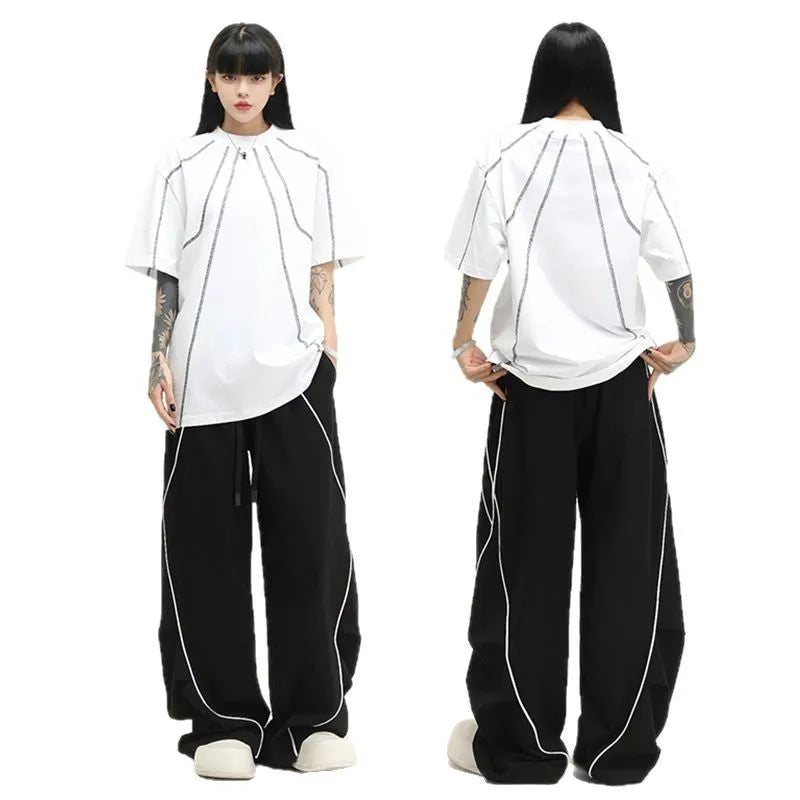 Black pleated hip hop trousers with wide-leg design and striped pattern