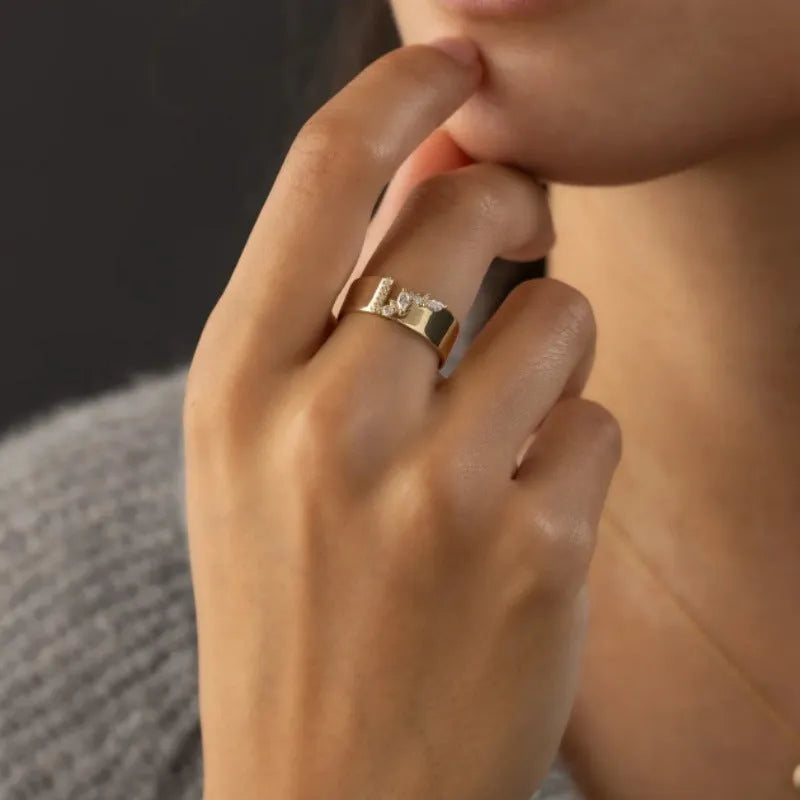 Gold plated copper ring for women with shining zircon detail on a finger.