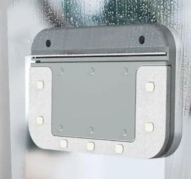 Magnetic double-sided window cleaner with silicone scraper on glass surface, 10x15x4cm size, white ABS body