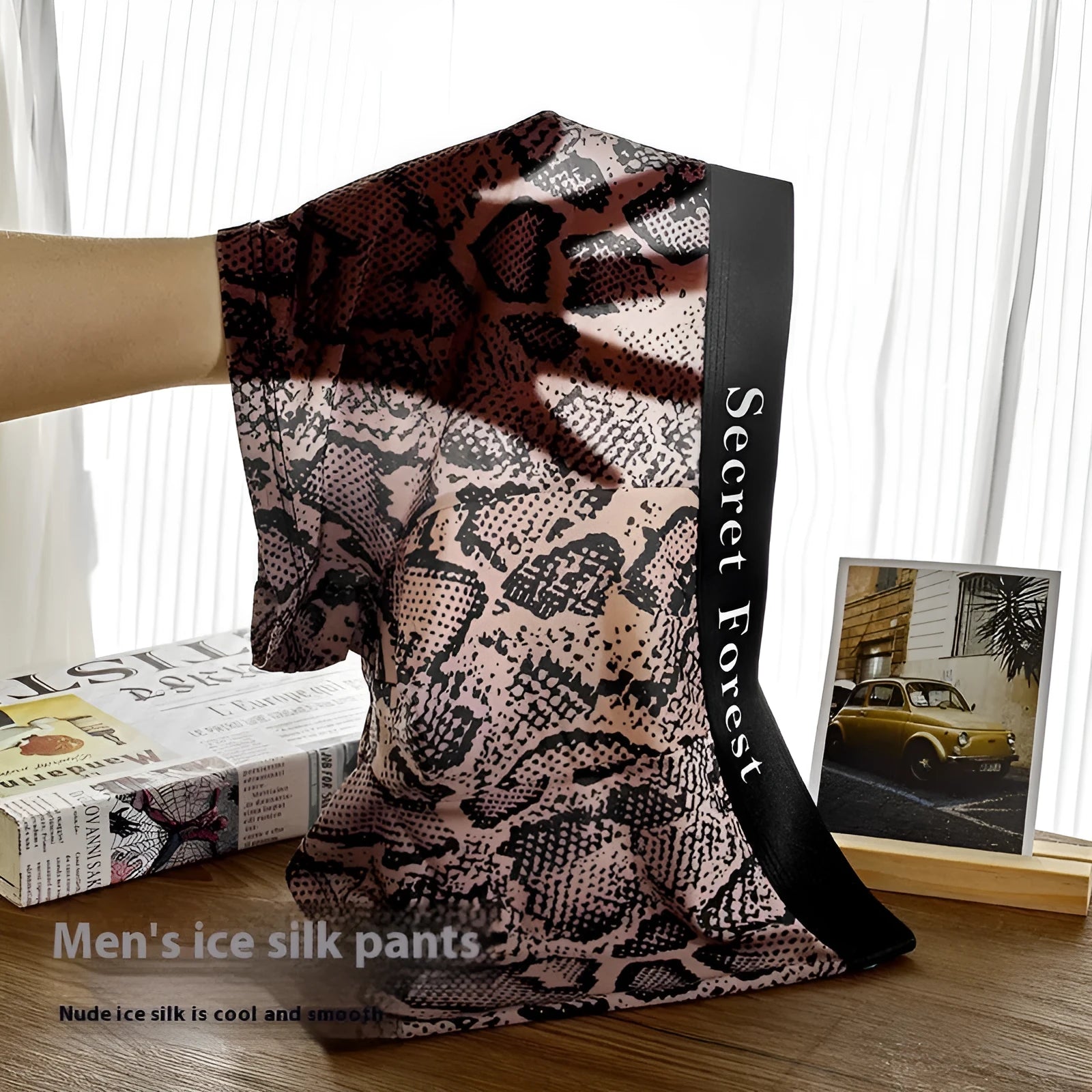 Men's thin loose knitted polyester boxer shorts in black, grey, and brown colours on a mid-waist model.