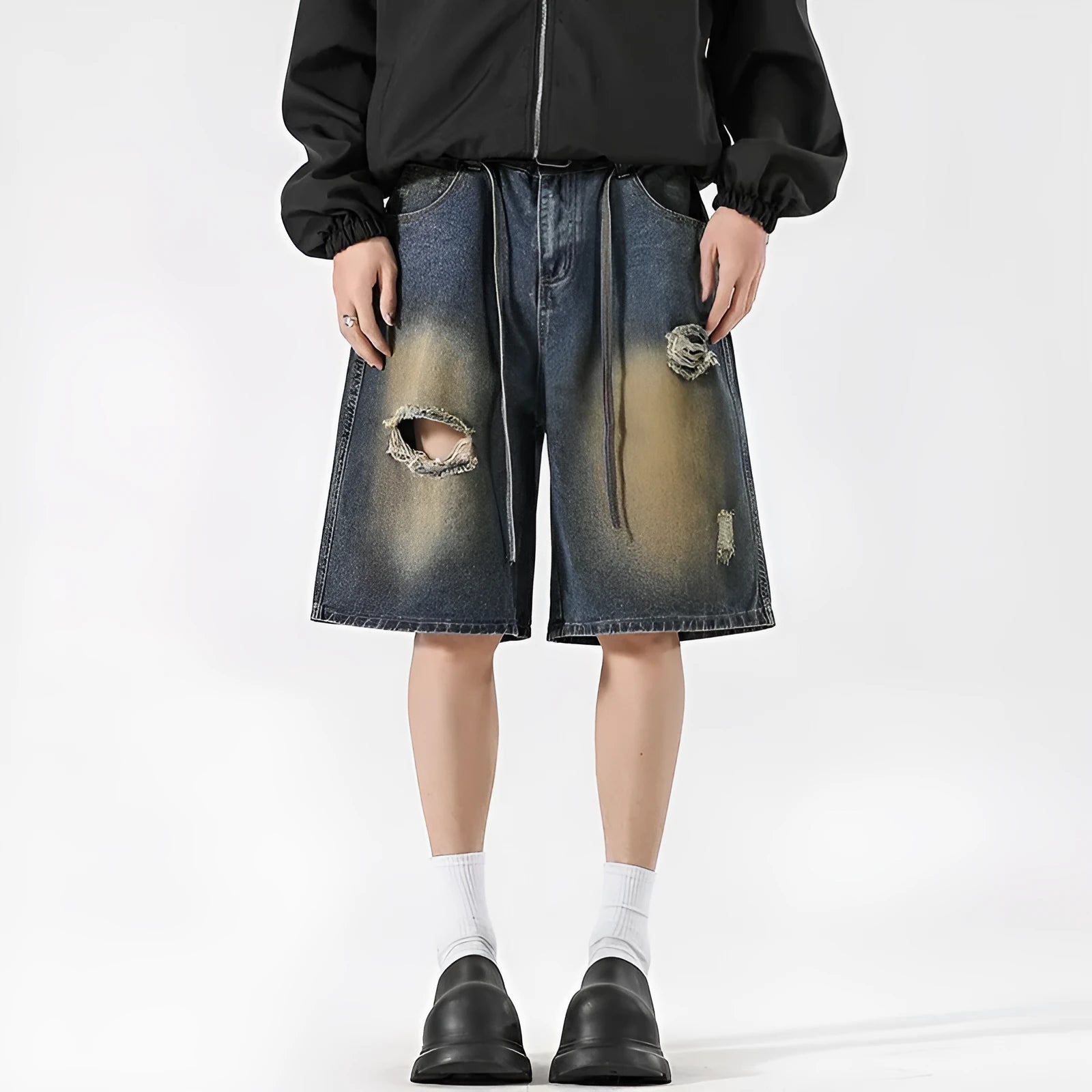 Men's retro blue loose-fit ripped jeans made from cotton denim, shown in a street style.