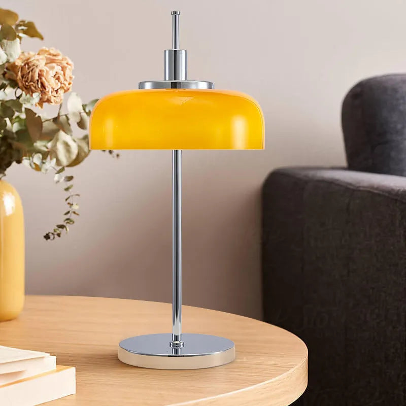 Retro table lamp with glass lampshade and chrome finish on a wooden surface