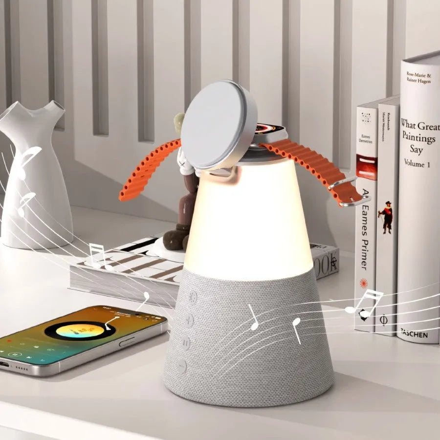 Grey 3-in-1 magnetic wireless charging Bluetooth speaker night light on a tabletop