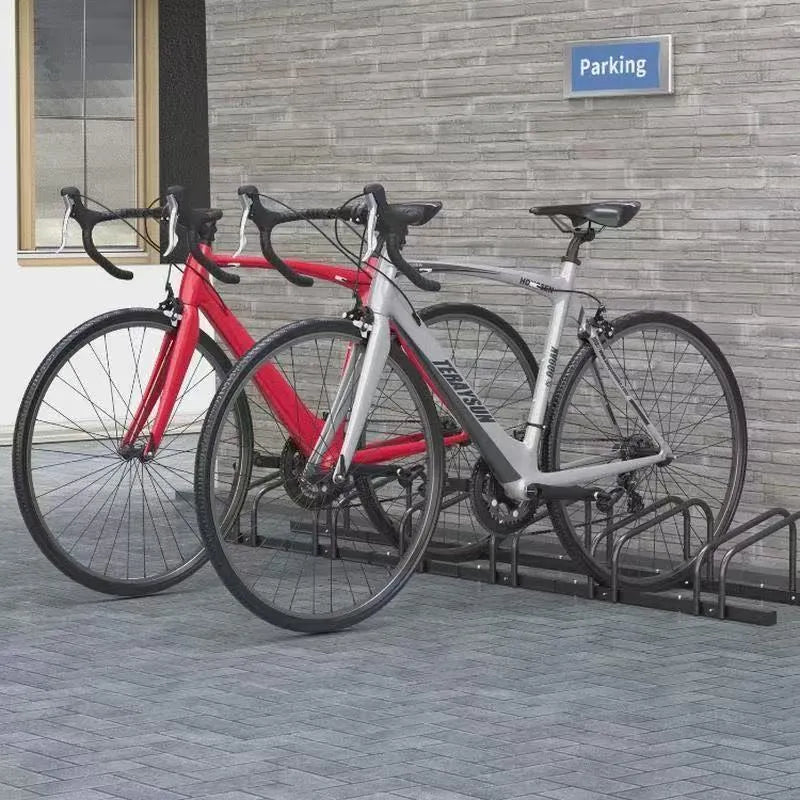 Black metal bicycle parking rack with four card positions holding bicycles upright