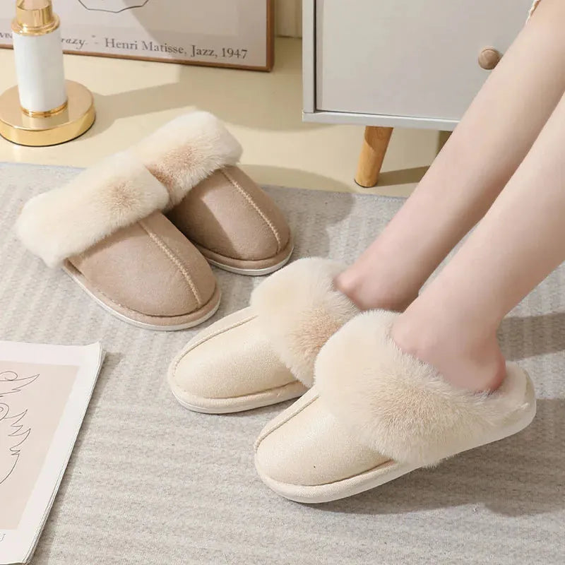 A pair of brown plush winter slippers with a round toe, flat heel, and non-slip PVC sole.