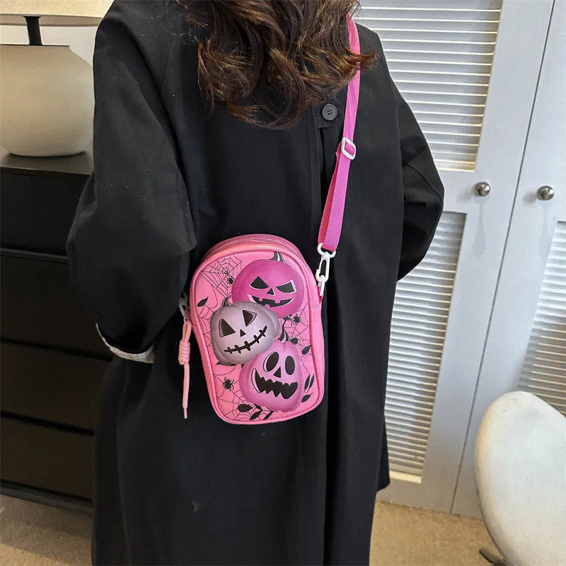 Halloween graffiti print crossbody bag with cartoon pumpkin ghost bat design in orange colour