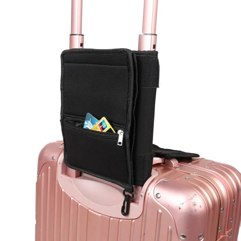 Black canvas large capacity packing tote folded flat on a surface, showing its storage pouch design