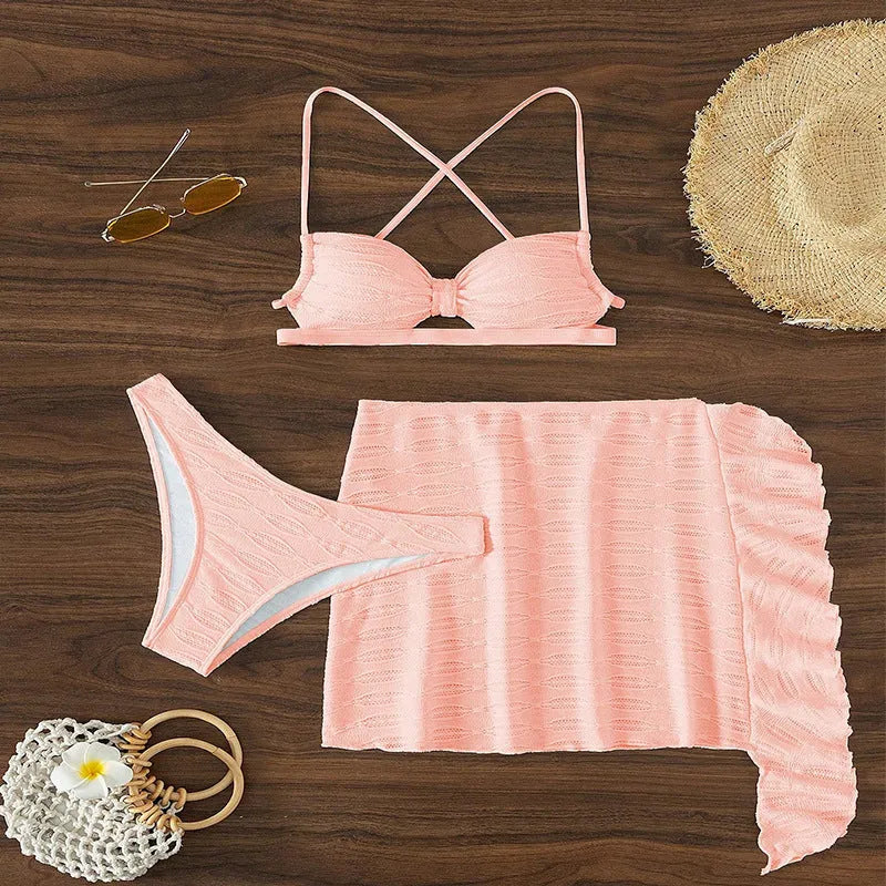 Women's lace-up bikini three-piece swimsuit set in light pink with swimsuit top, tie pants, and coordinating skirt