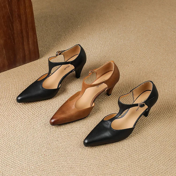 Brown retro women's T-strap sandals with a closed toe, buckle fastening, and a short stout heel.