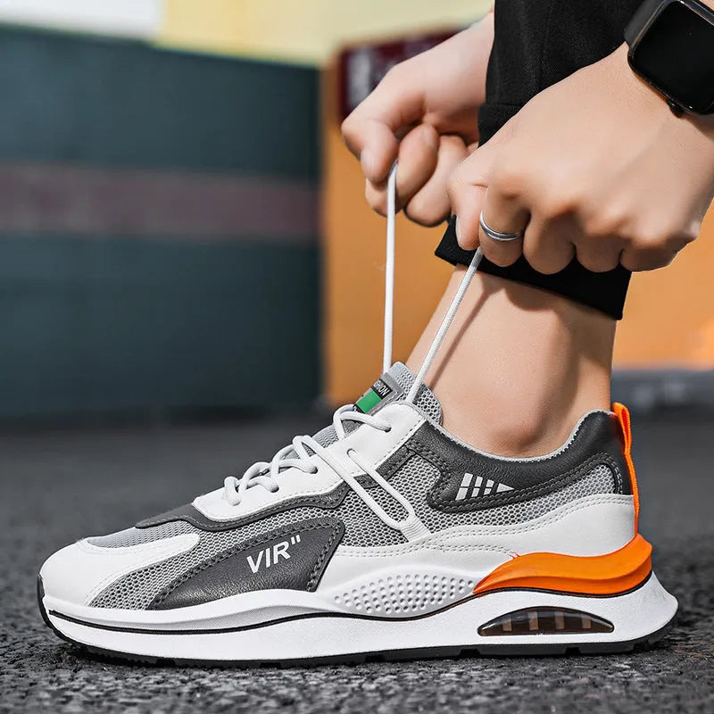 Men's grey and black mesh running shoes with round toe and mid-top design on white background