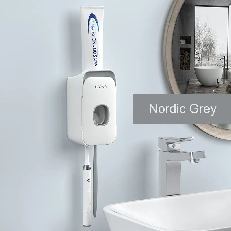 Blue automatic toothpaste dispenser mounted on a bathroom wall with a transparent window showing paste inside.