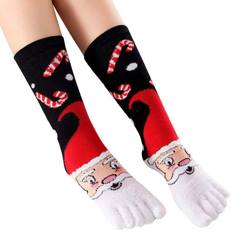 Christmas five finger socks with cartoon patterns in black, green, and white on a neutral background