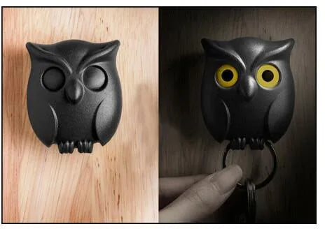 Magnetic wall key holder in white with attached keychains on a wall surface