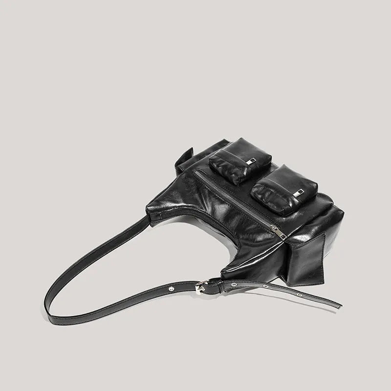 Black PU leather shoulder motorcycle bag with sewing line details against a plain background