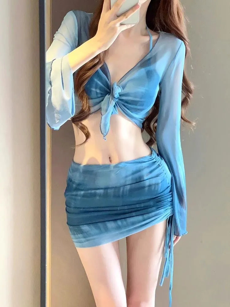 Women's blue four-piece bikini swimsuit set with high-waist briefs and ruffle skirt