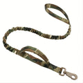 Retractable leash for large dogs in black with anti-burst technology on a grassy park background