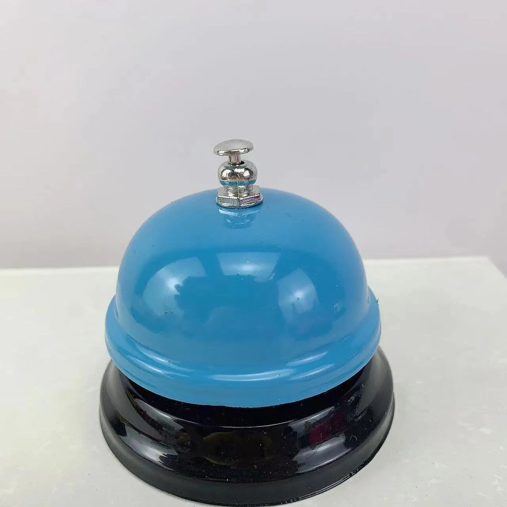 Iron hand bell with handle in one of eleven available colours, including red, green, blue, and pink.