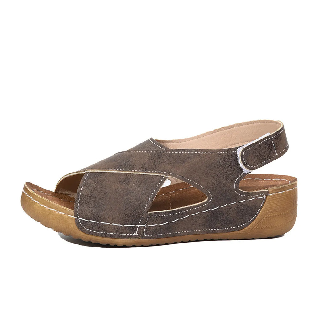 Women's brown Roman platform sandals with a skirt detail and Velcro strap.