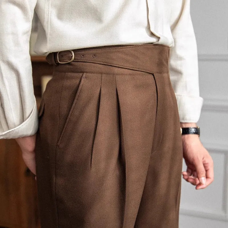Man wearing black high waist straight leg casual trousers made from polyester fabric.