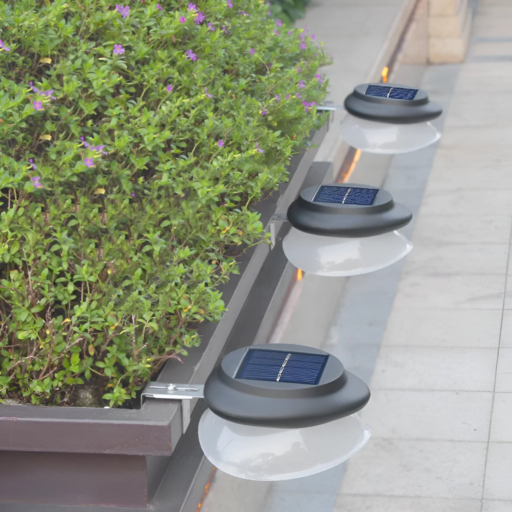 Solar-powered outdoor fence wall lamp in garden setting with 9 LED illumination