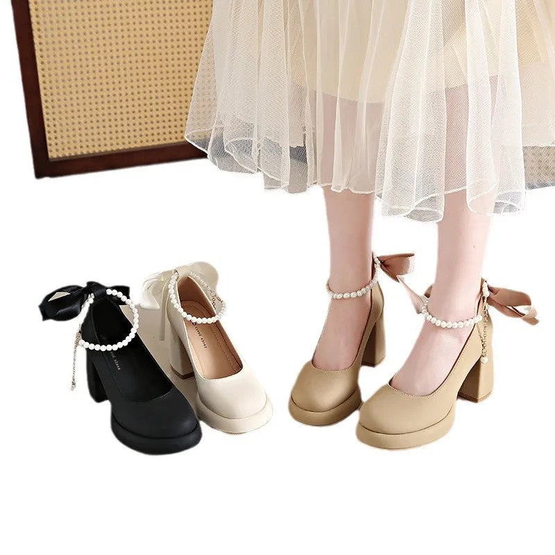 Women's beige Mary Jane shoes with chunky heel and ankle-strap buckle on a neutral background