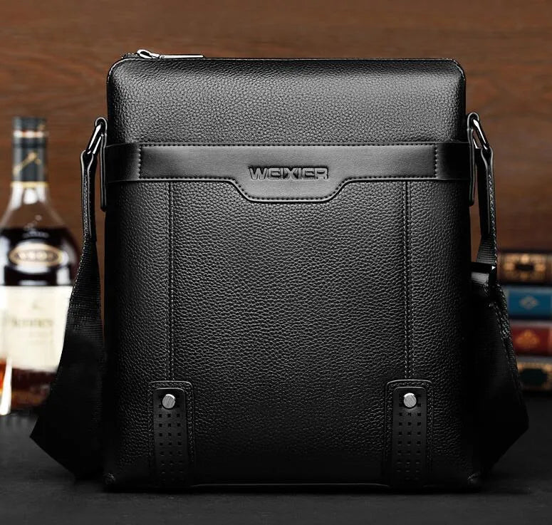 Men's PU leather messenger bag in black with zipper closure, soft body, and crossbody strap.