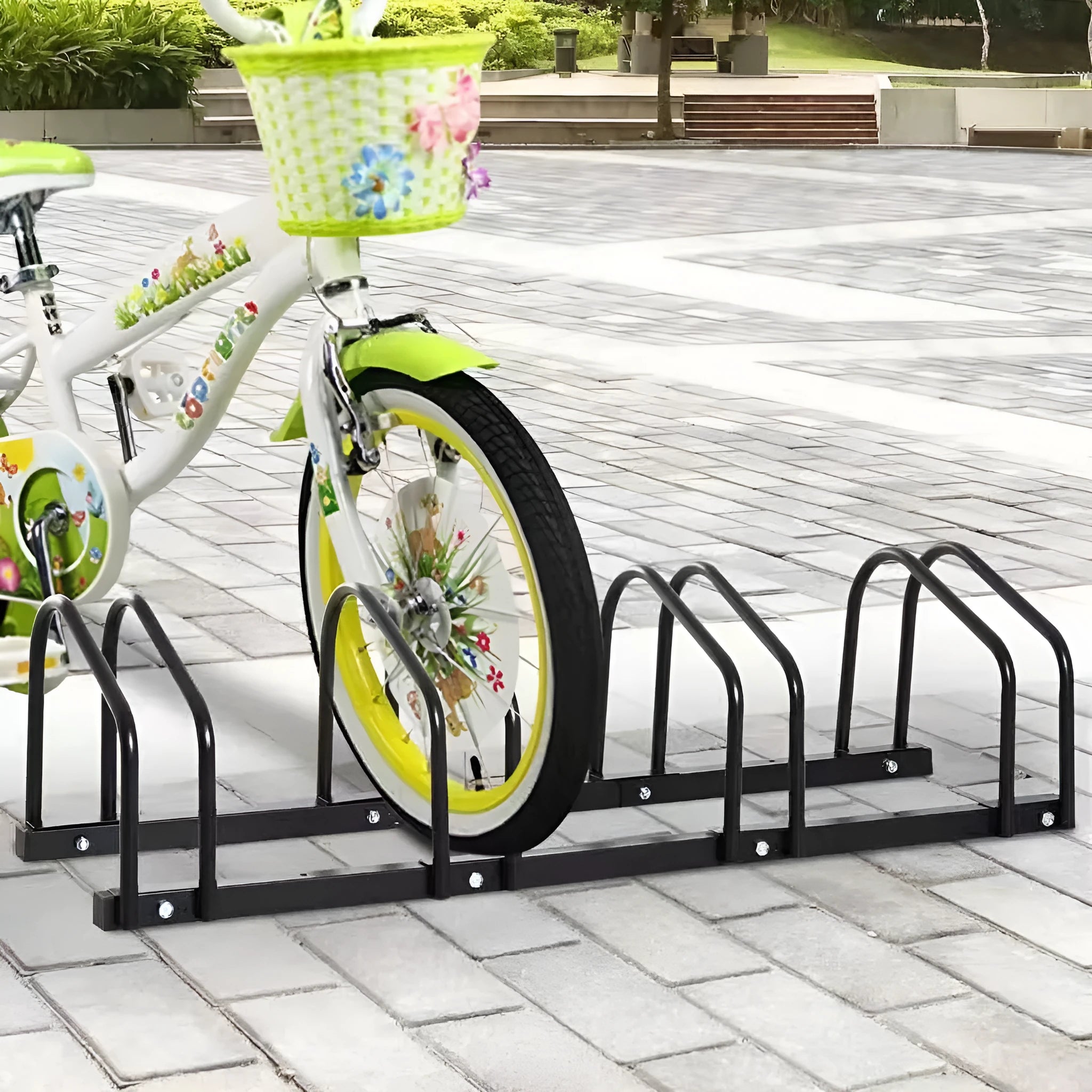 Black metal bicycle parking rack with four card positions holding bicycles upright